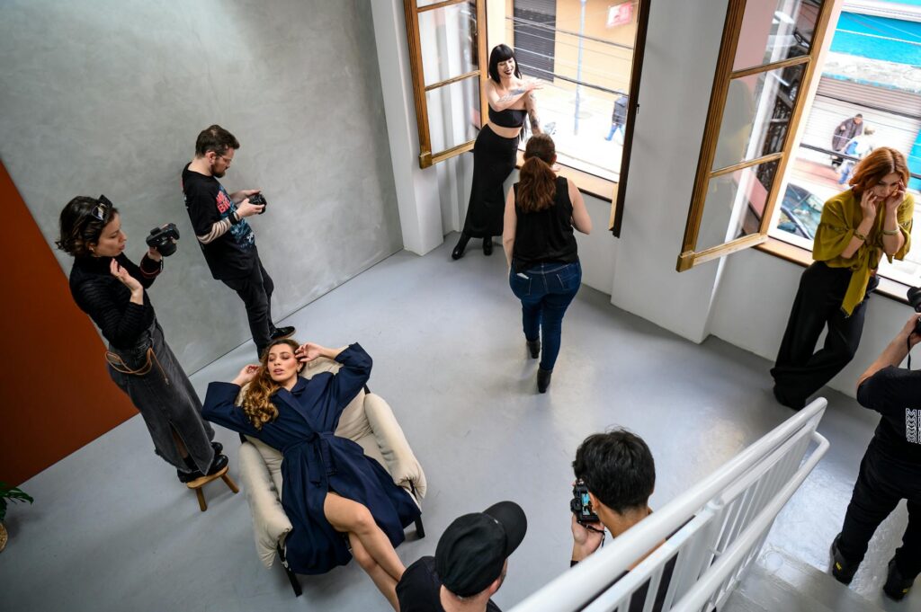 A dynamic fashion photoshoot capturing model poses and photographers at work in a modern studio in Curitiba.